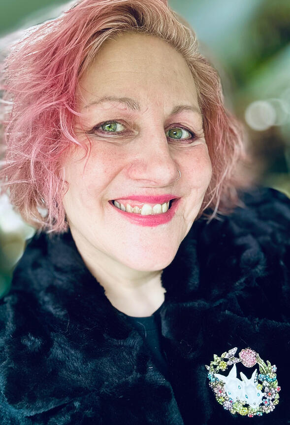 Selfie Mandy Millie Flockton selfie image 3/4 profile smiling pink hair bunnies brooch